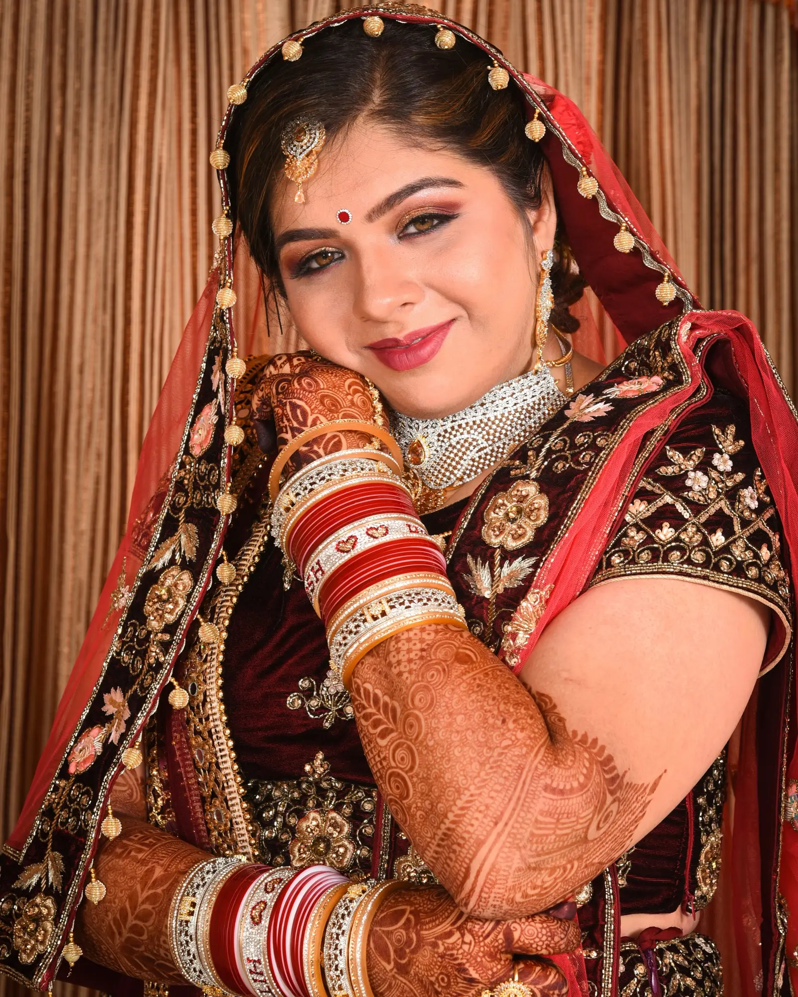 Bride in red and gold bridal wear, bridal makeup by Shadows Beauty Parlour, Khar West, Mumbai